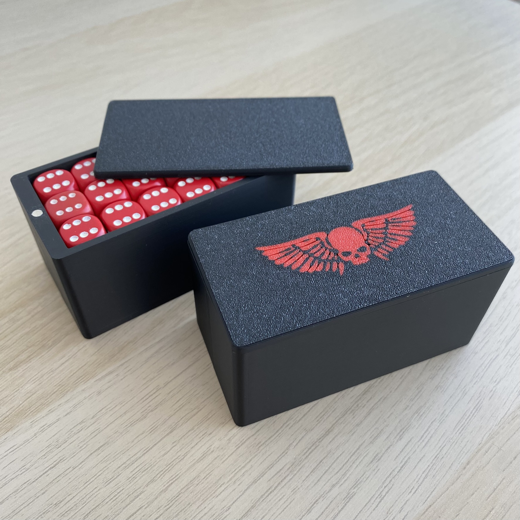 3D-printed dice storage box with red dice